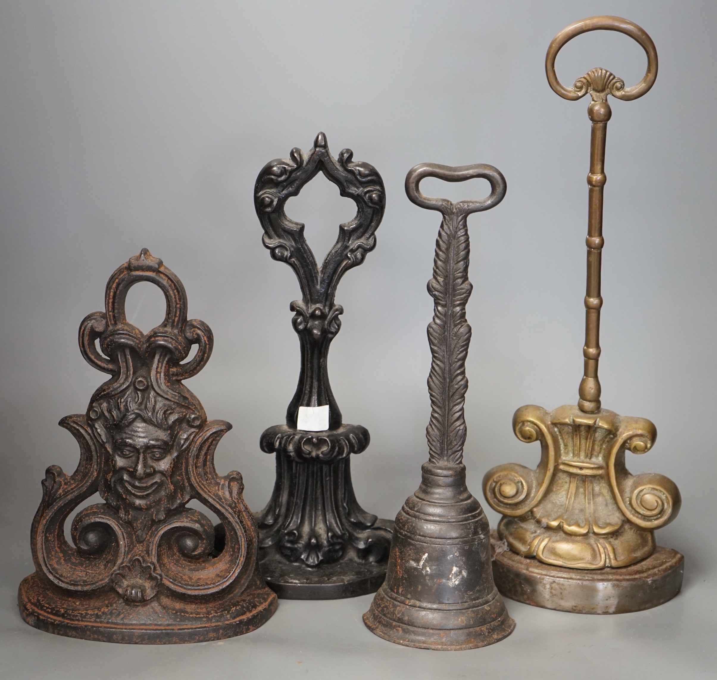 Four cast iron Victorian assorted door stops, tallest 38cm